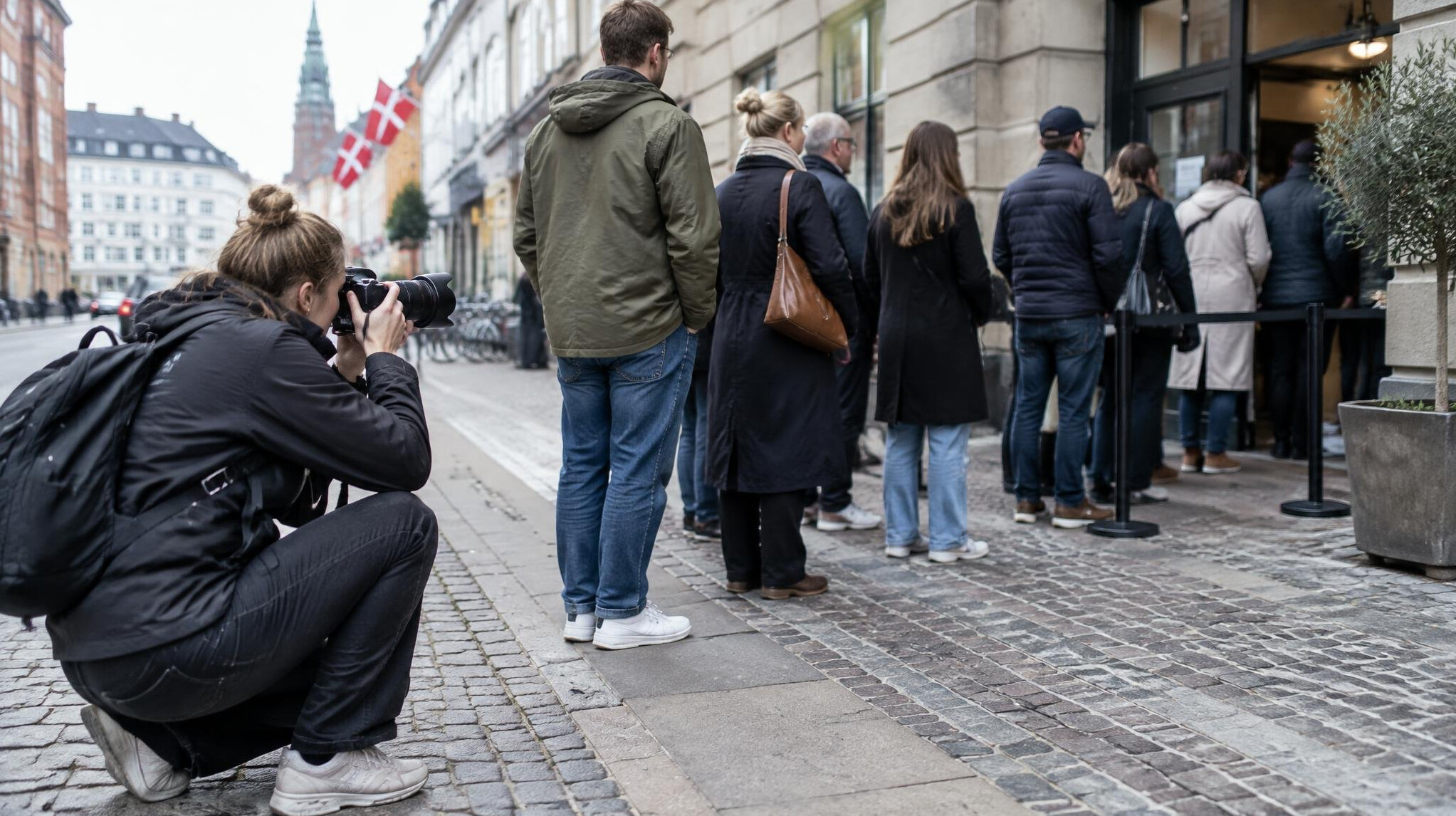 Photographer taking pictures of people waiting in a queue